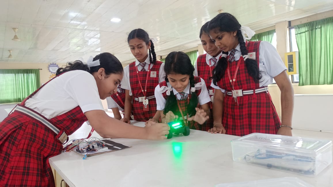 Students working with technology and robotics in a Pragati Academy learning lab